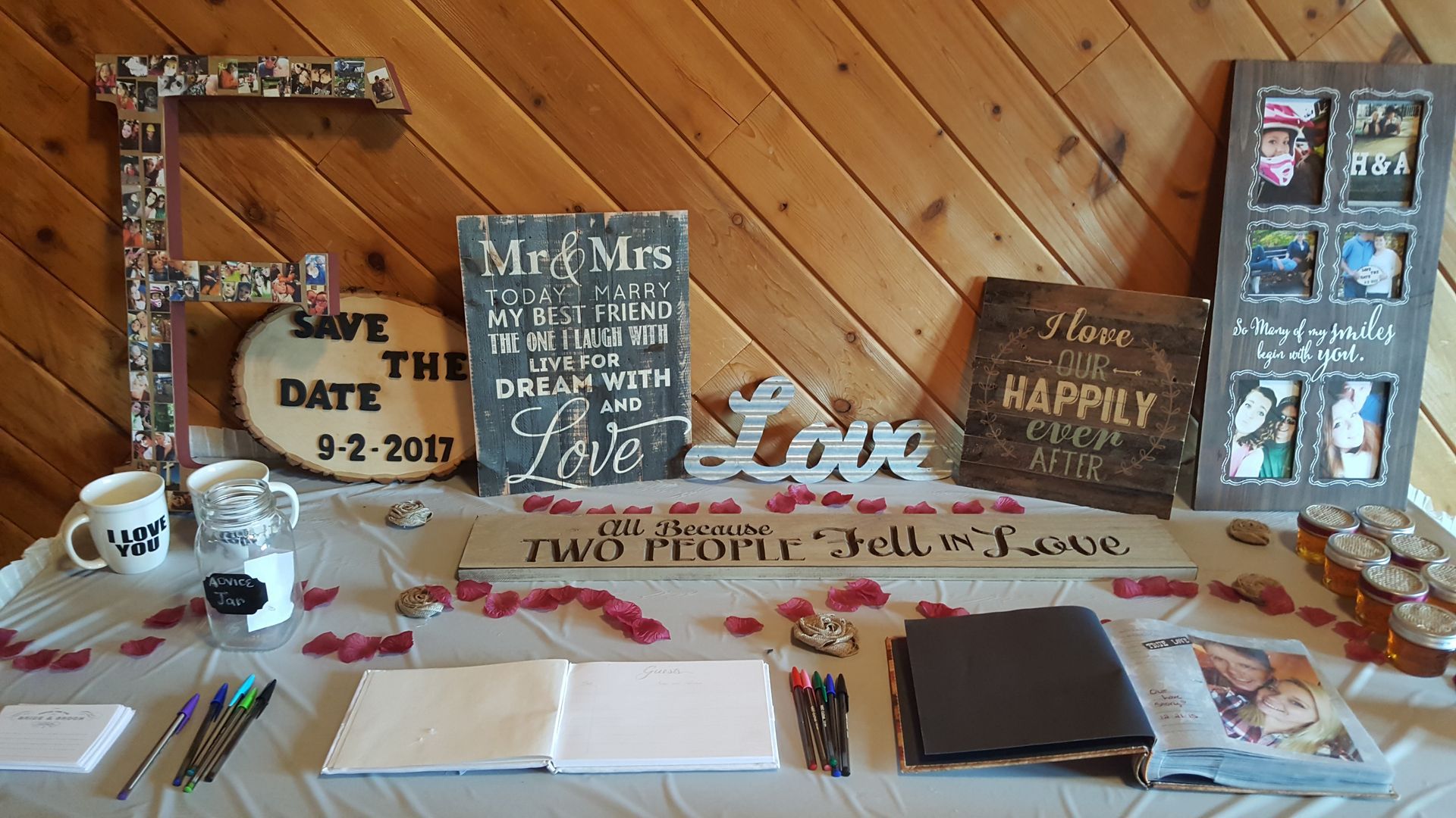 Rustic graduation display with photos, cupcakes, snacks, and a “Class of 2017” sign on a table