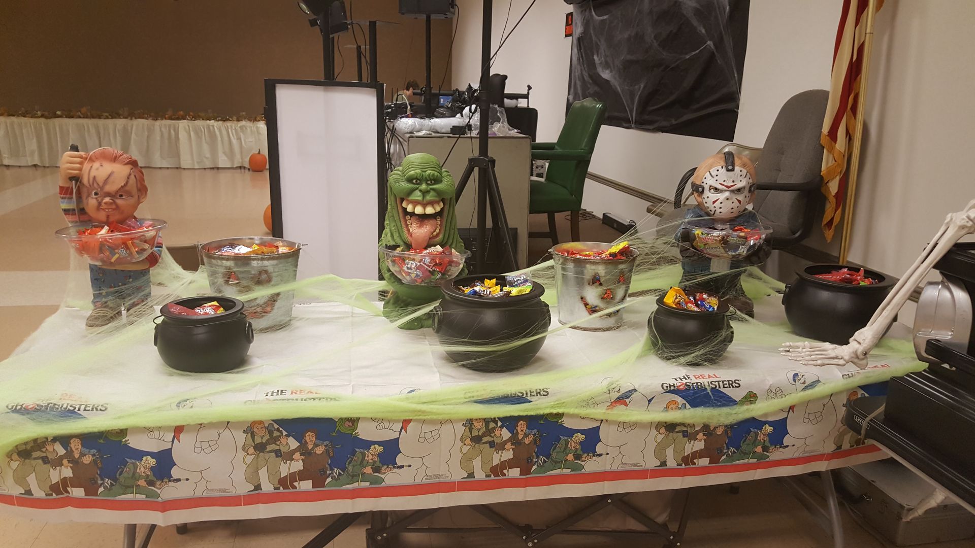Table set with bowls of food, a framed photo, and candles in a decorated room.