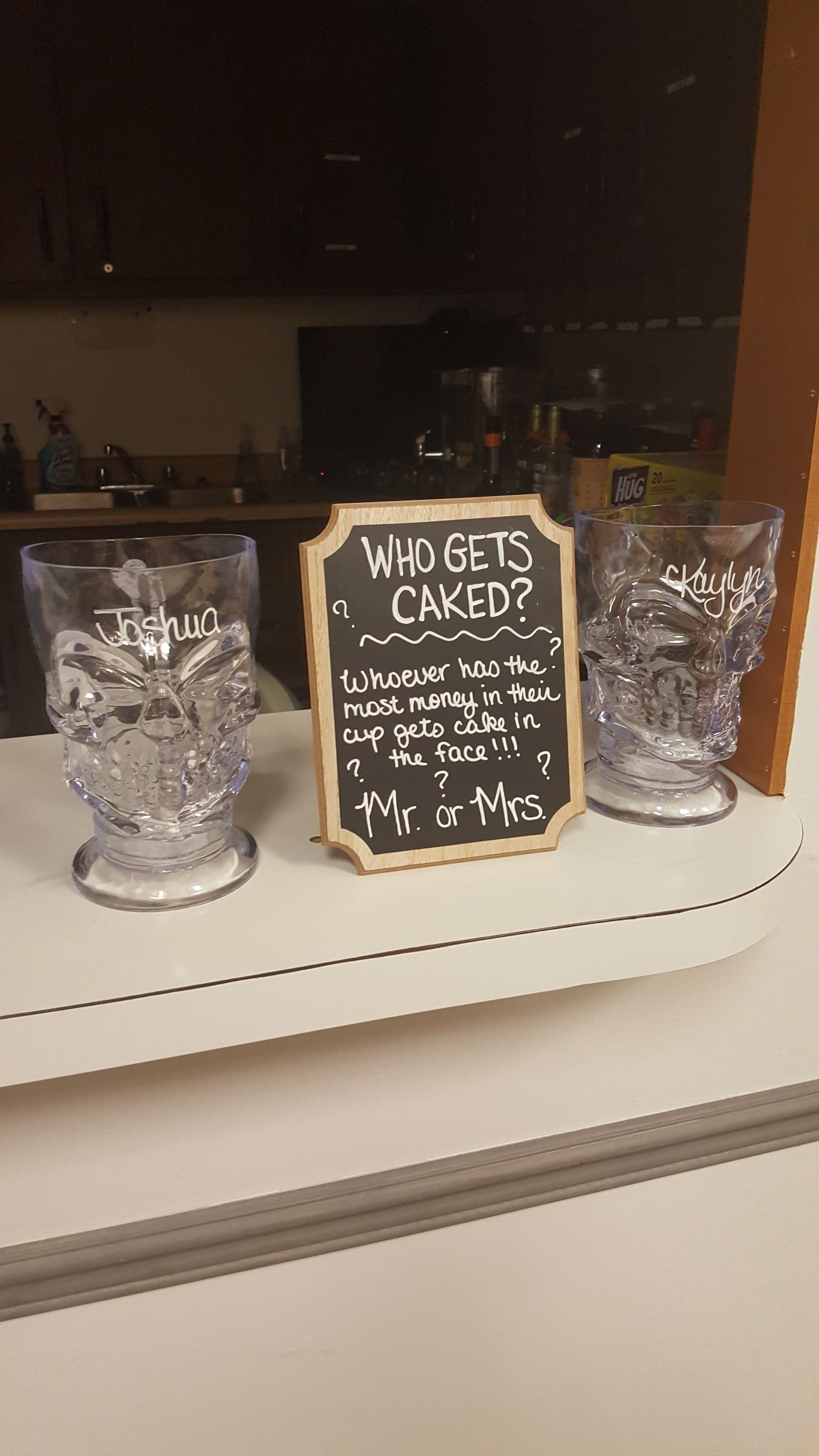 Three glass jars and a chalkboard sign reading “HANDS CANCELED?” on a store counter