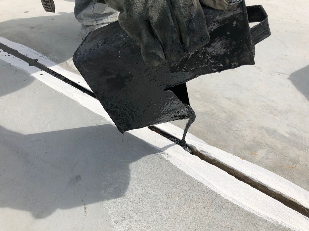 A Person Is Applying A Black Liquid To A White Line On A Concrete Surface — Pigot's Midwestern Mini Mix In Orange, NSW