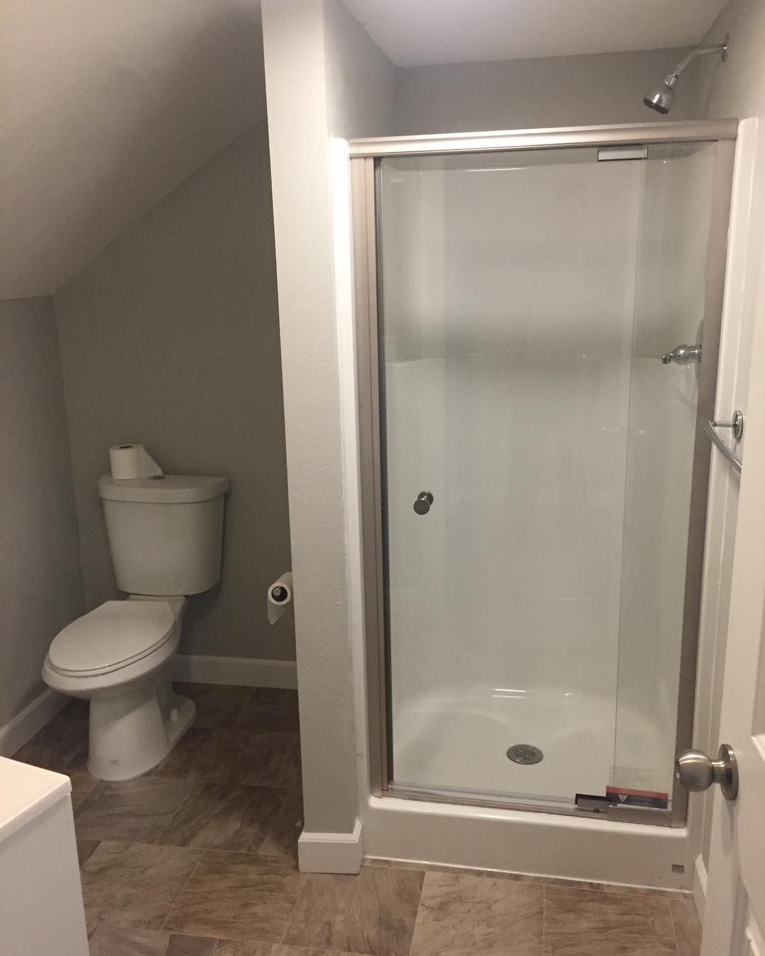 There is a toilet and a shower in the bathroom.