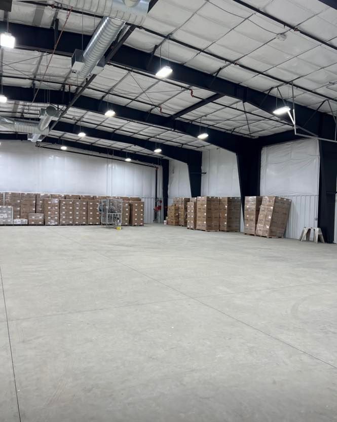 A large warehouse filled with lots of cardboard boxes