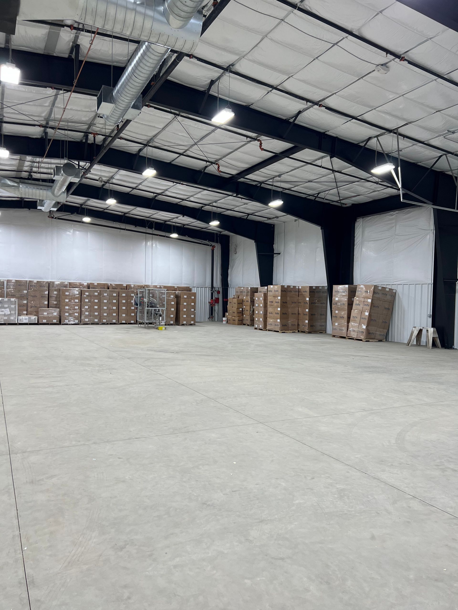 A large warehouse filled with lots of cardboard boxes
