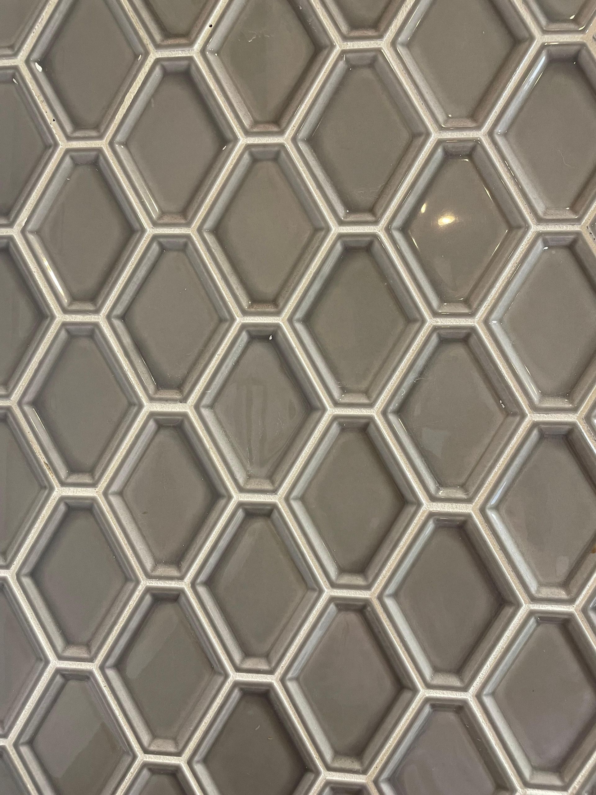 A close up of a tile that looks like a honeycomb.