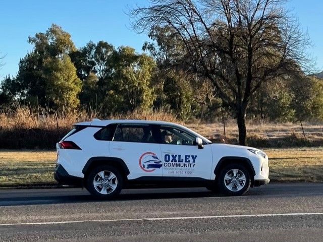 Oxley Community Transport Team Unpacking Belongings — Aged Care Transport in Tamworth, NSW