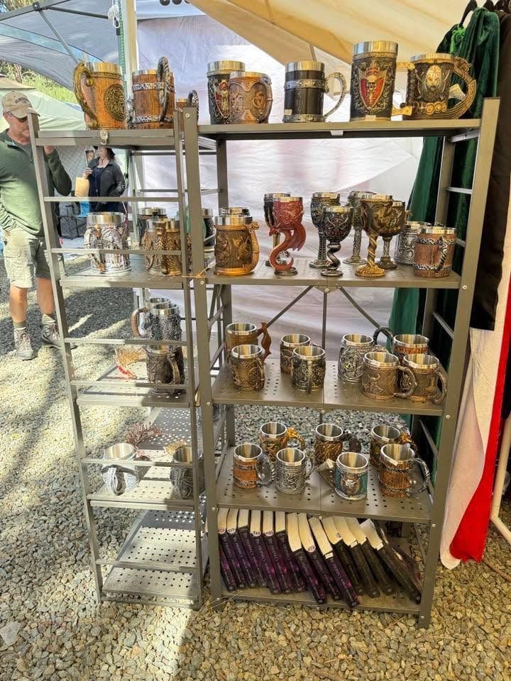 Metal shelf display of patterned mugs and cups at an outdoor market stall