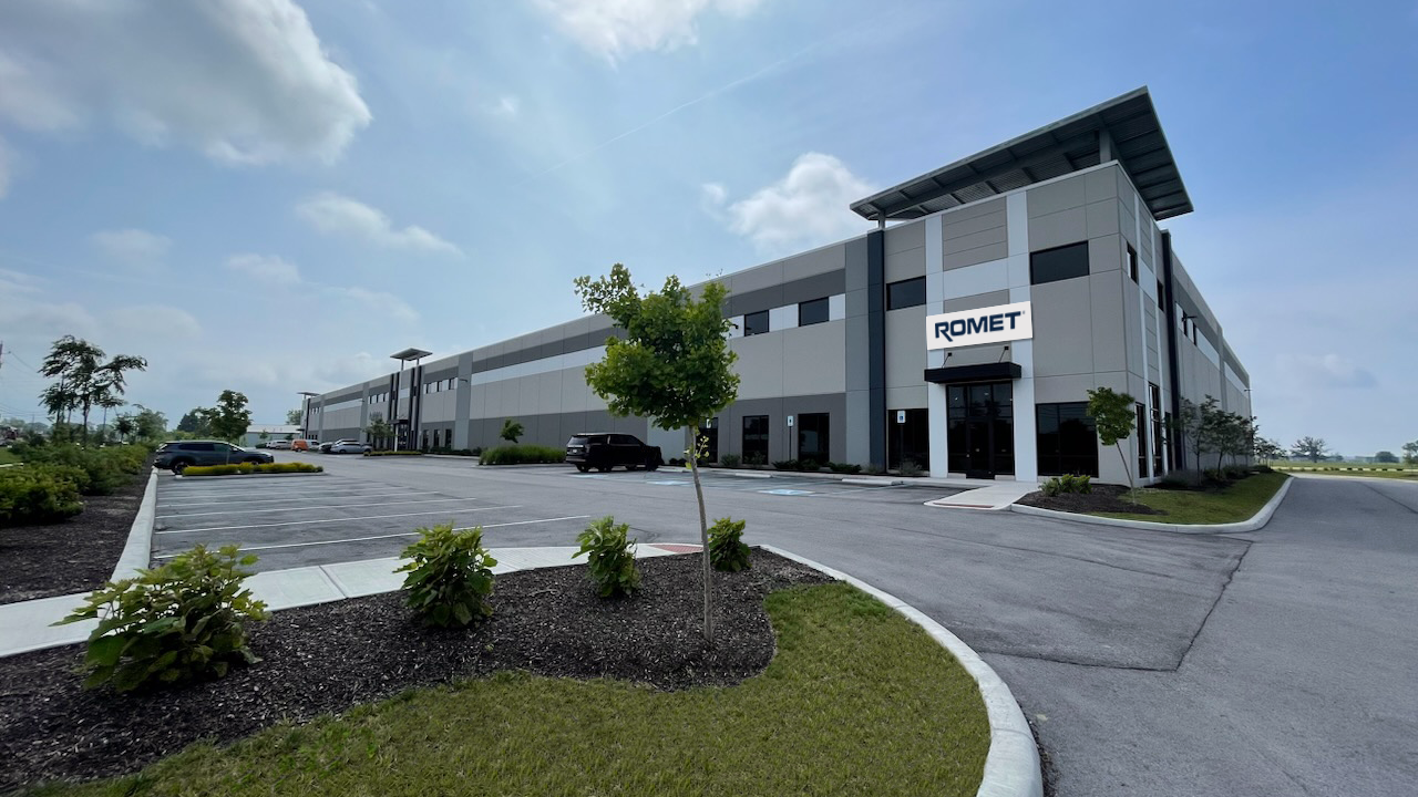 A large new manufacturing building with Romet sign on the front