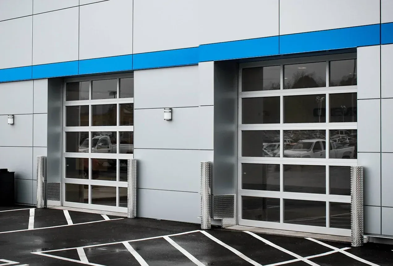 A building with a lot of windows and a parking lot in front of it