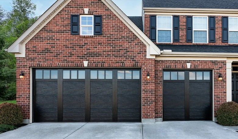 A brick house with black garage doors and black shutters in Palmetto Ga