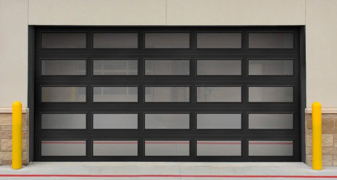 A black garage door with a lot of windows and yellow poles.