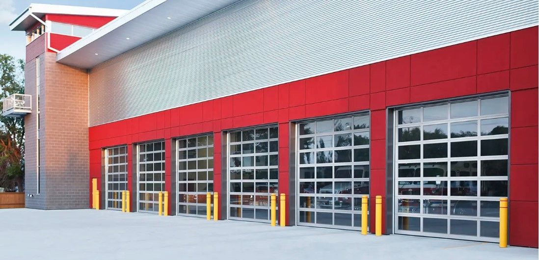 A red and silver building with a lot of garage doors.