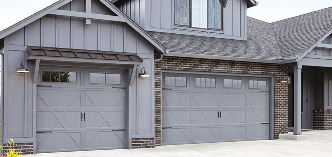 There are two garage doors in Palmetto Ga on the side of a house.