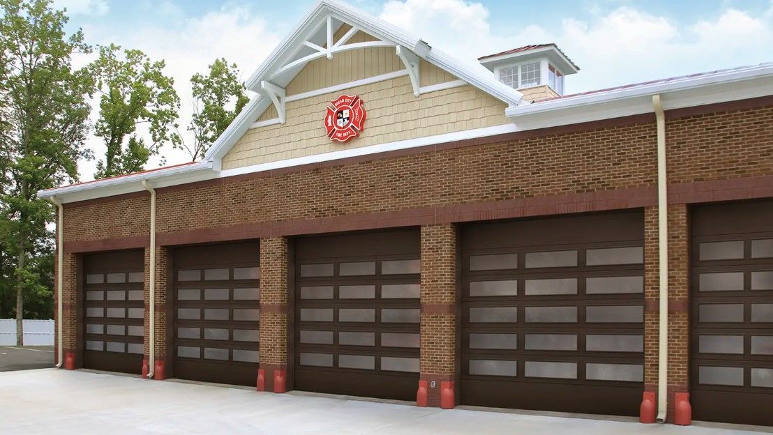 A row of garage doors are lined up in front of a building.