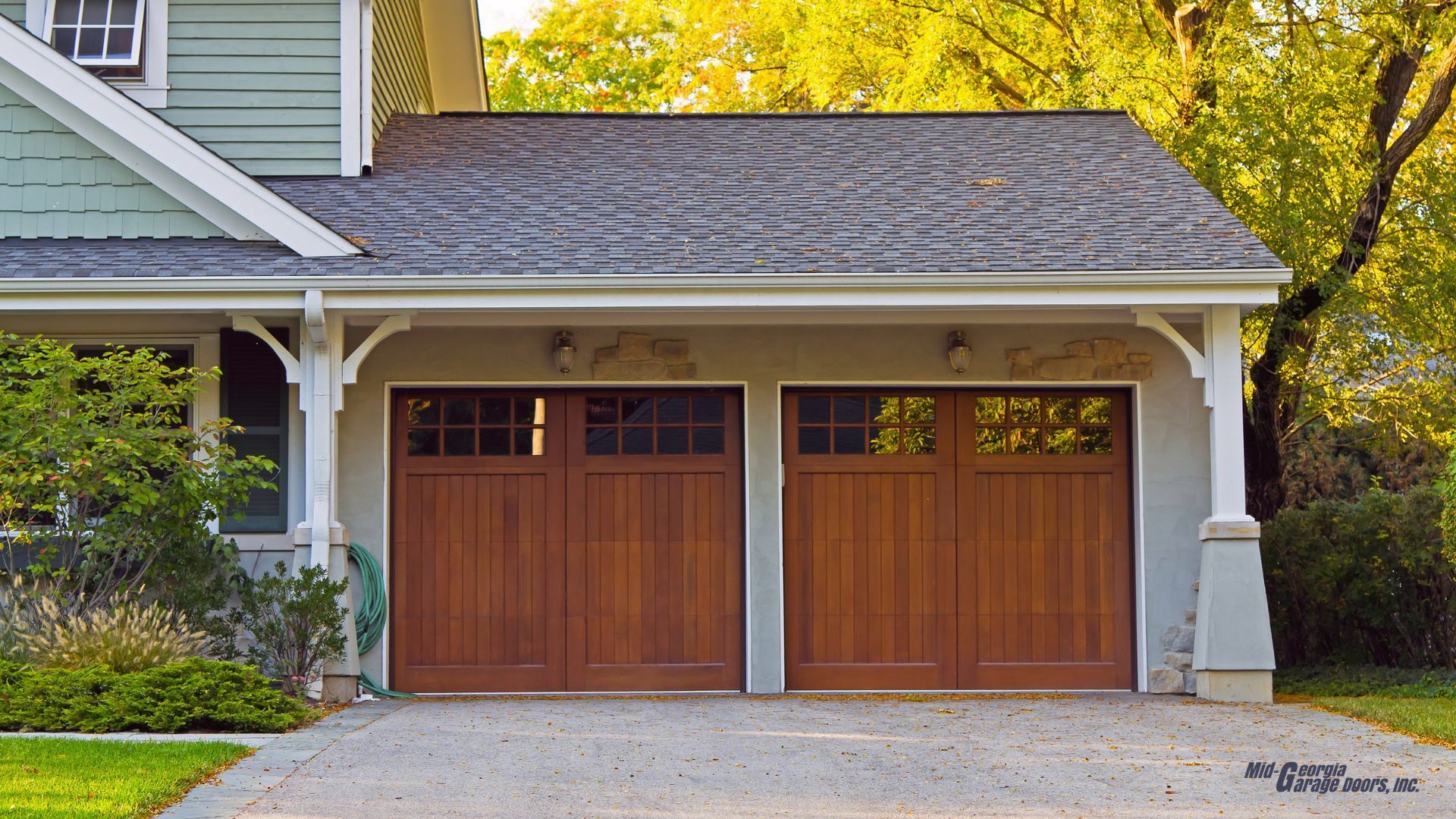 A house with two wooden garage doors and a driveway in Palmetto Ga