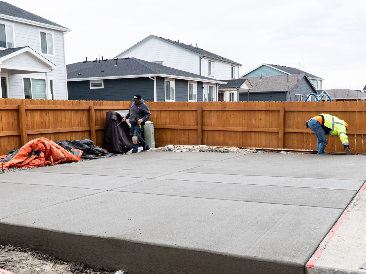 A concrete foundation is being built in a residential area.