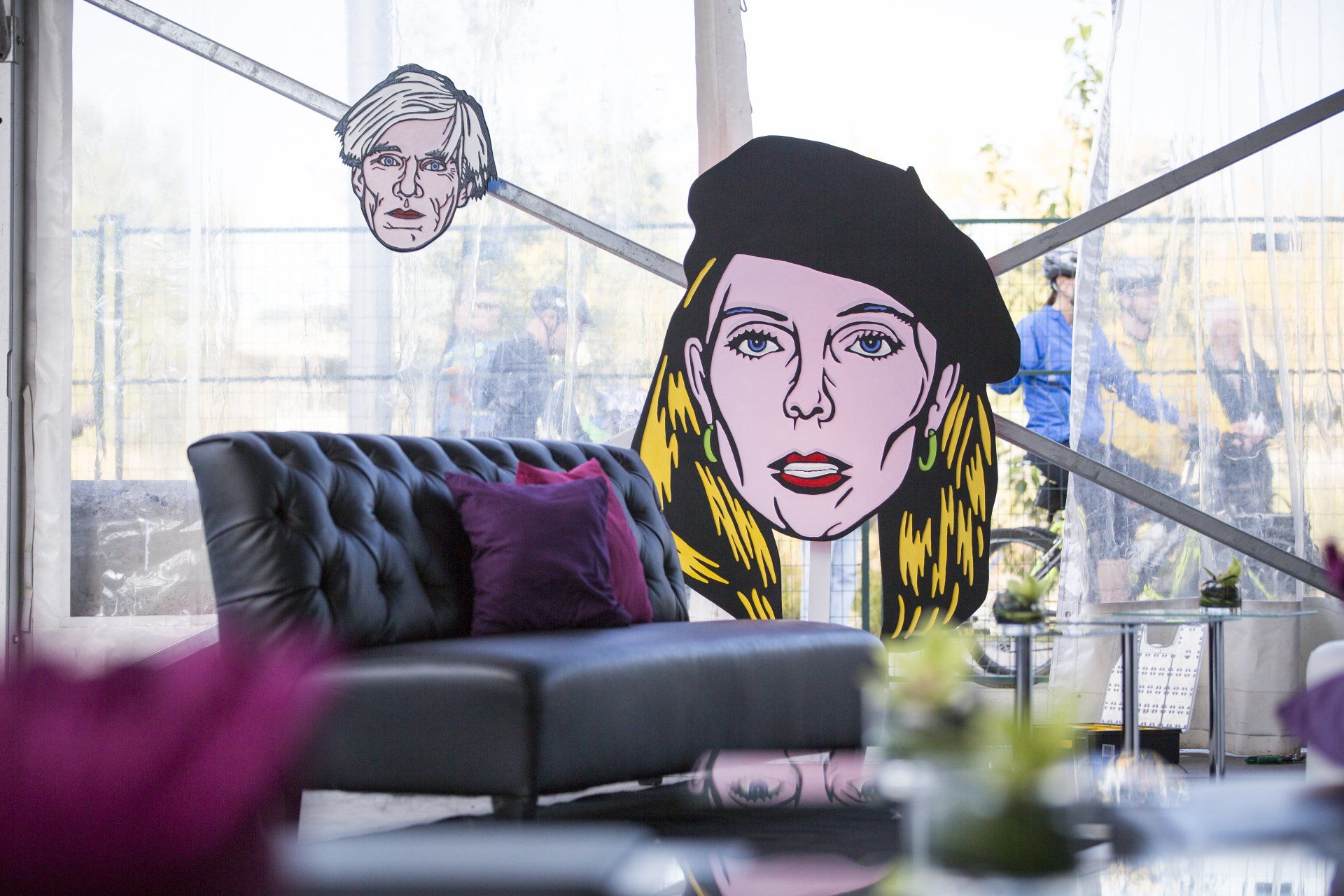 A couch with a painting of a woman 's face on it.