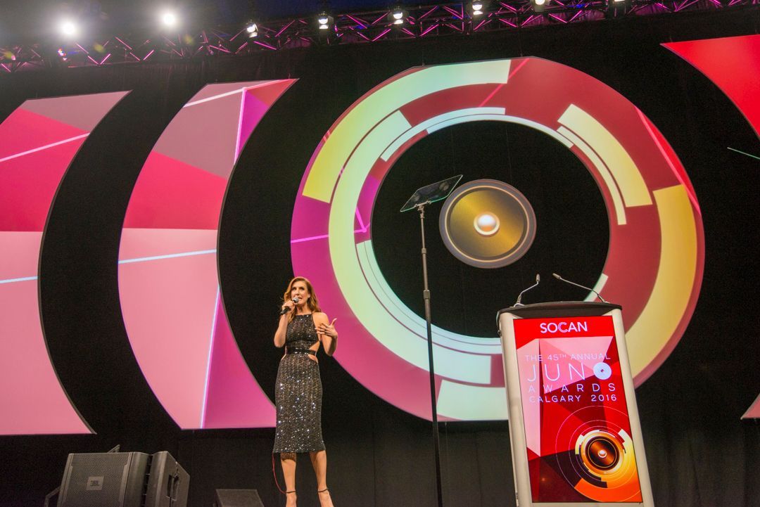 A woman singing into a microphone on a stage
