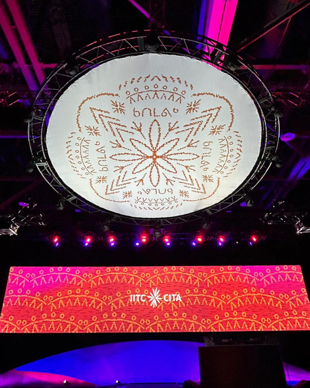 A large white circle with a flower on it is hanging from the ceiling.