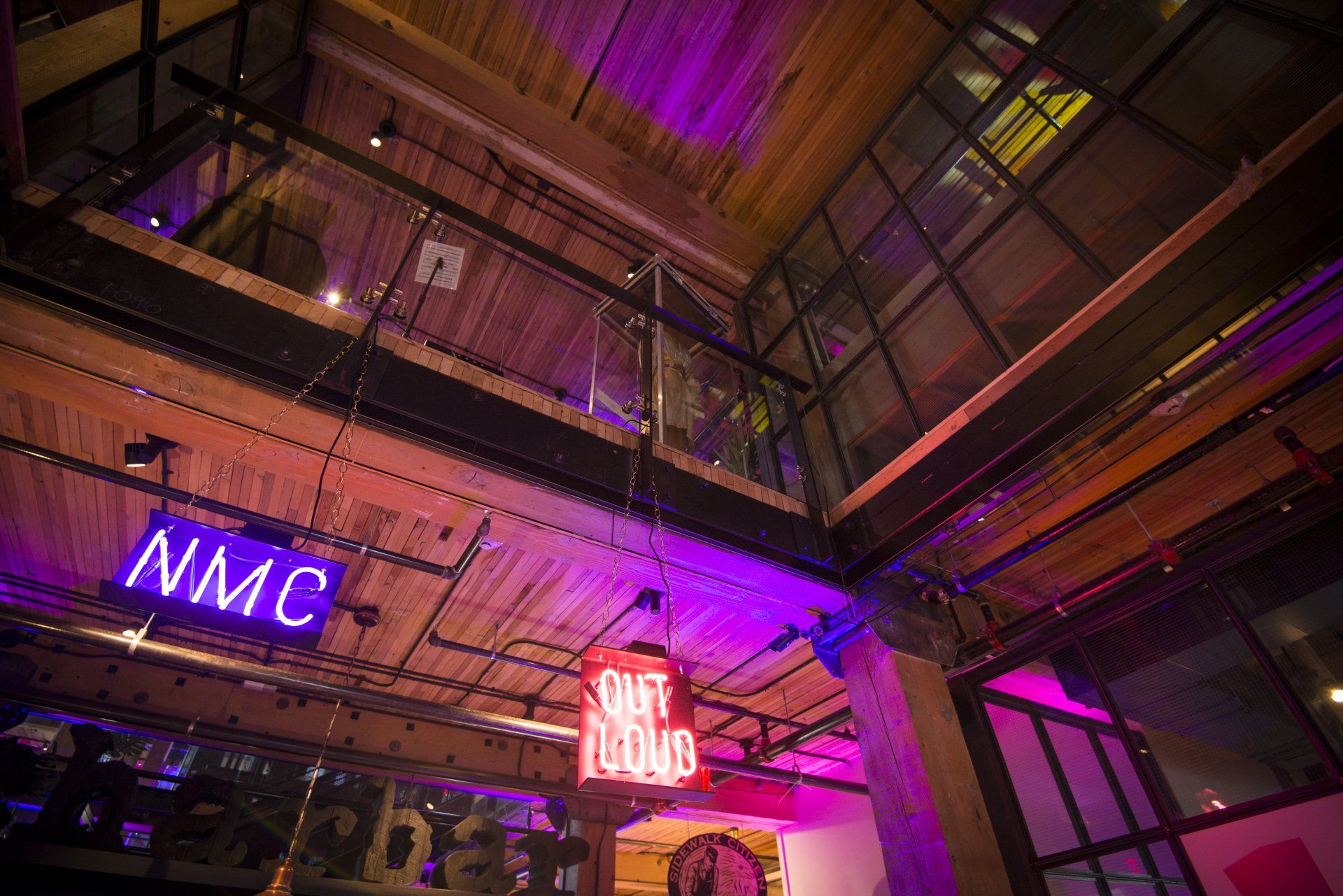 A building with a lot of lights on it and a sign that says nmc