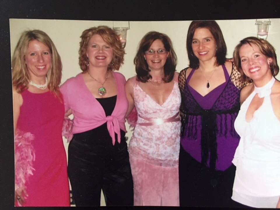 A group of women are posing for a picture together