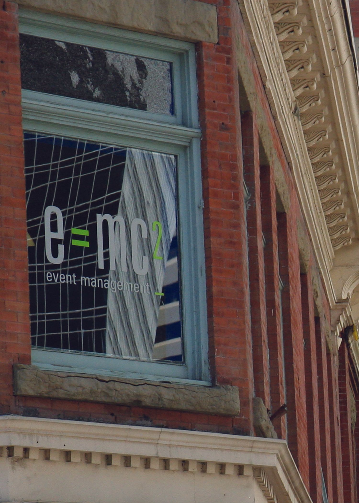 A brick building with a window that says e = mc2