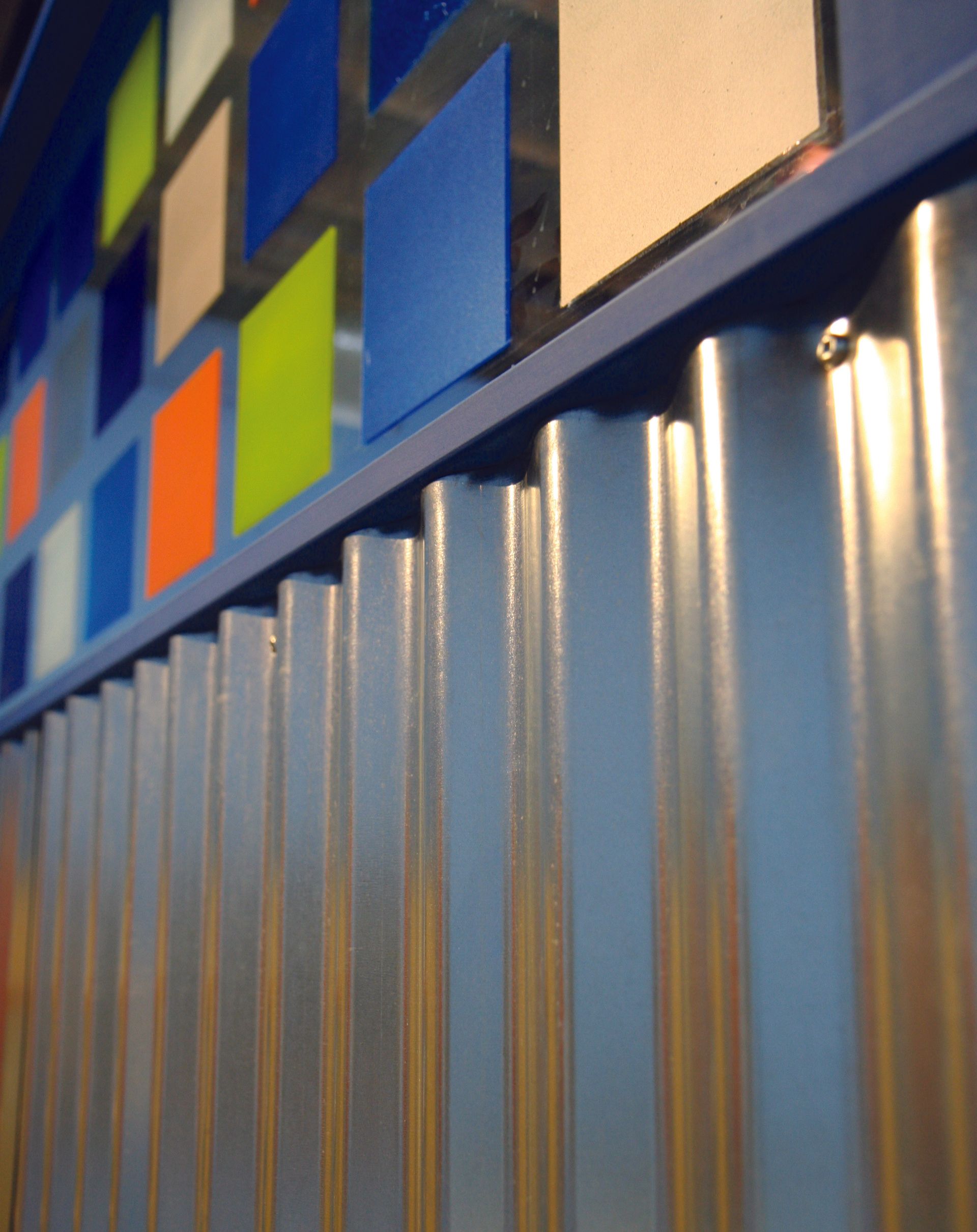 A close up of a metal wall with a painting on it