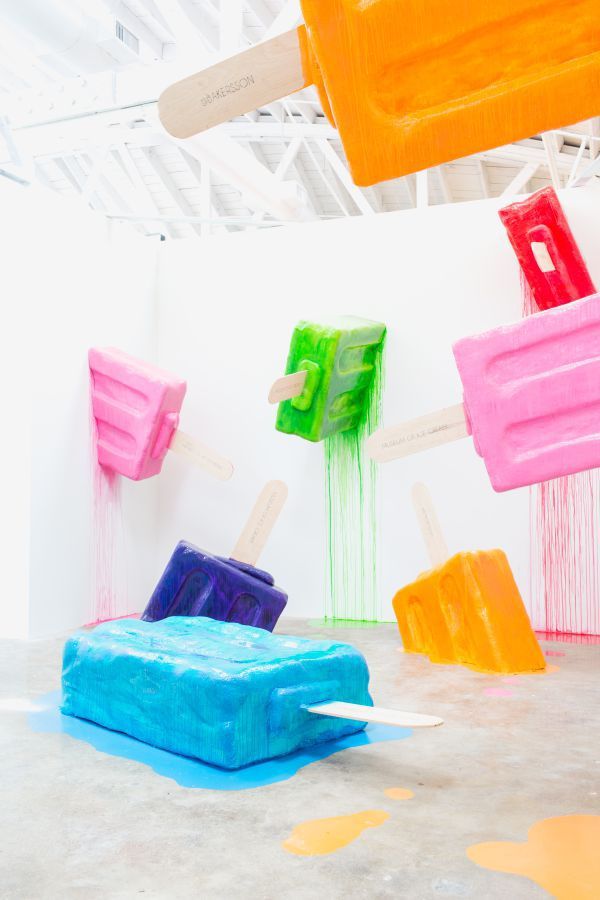 A bunch of popsicles are sitting on the floor in a room.