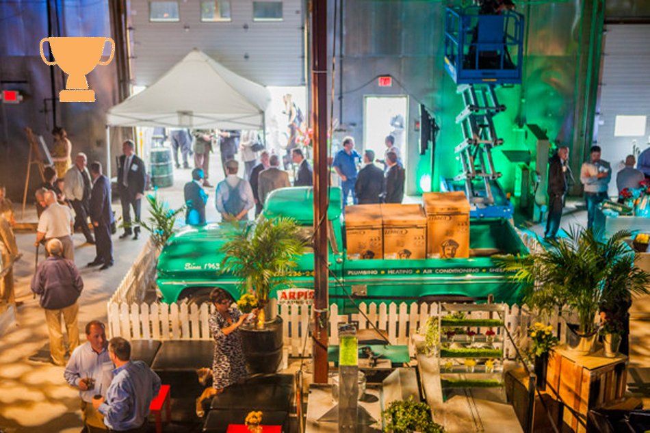 A group of people are standing around a green truck.