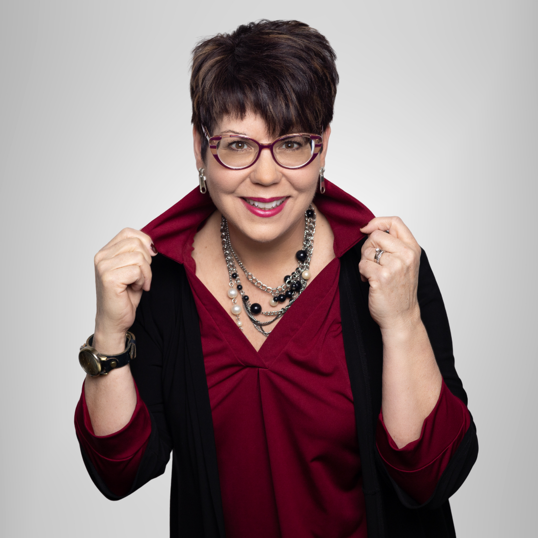 A woman wearing glasses and a red shirt is smiling