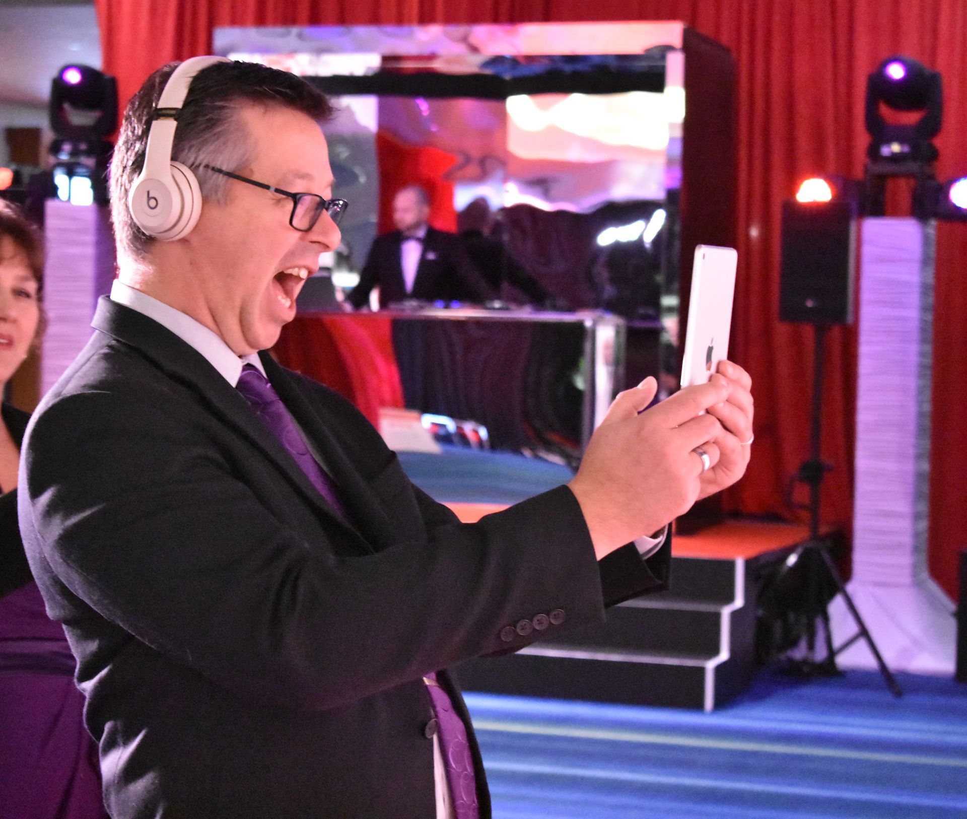 A man wearing headphones is taking a picture of himself