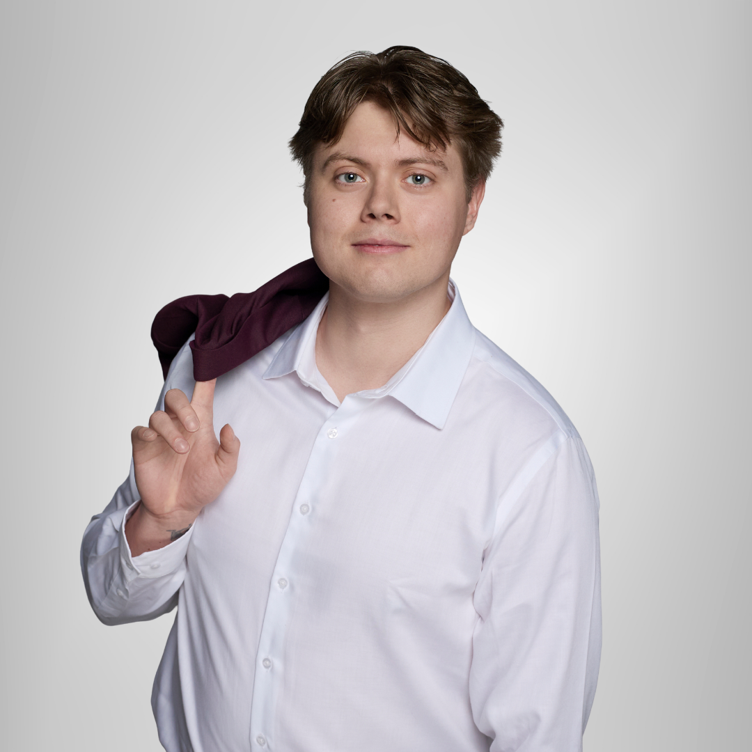 Person in a white shirt holding a dark jacket over one shoulder against a light gray background