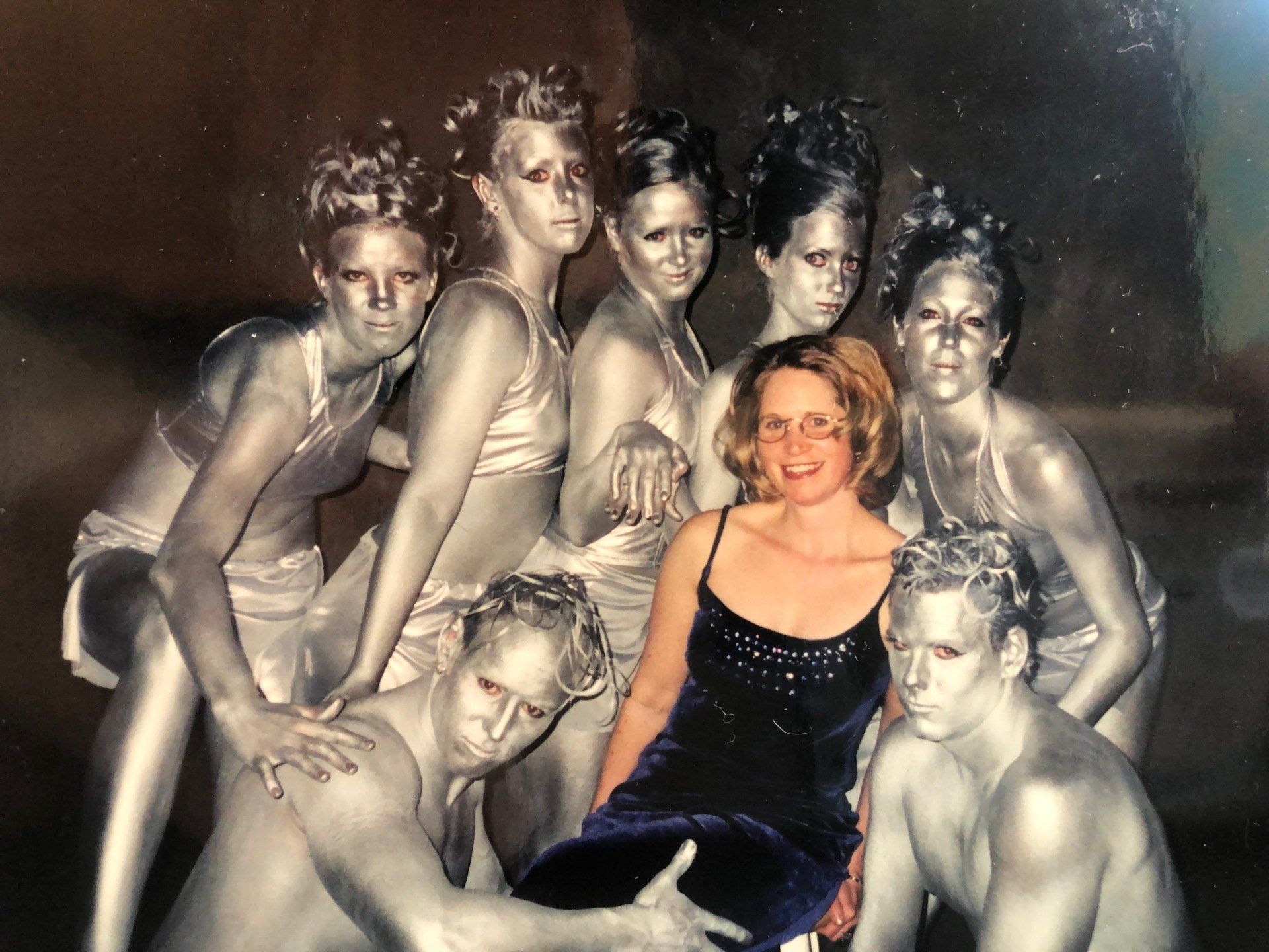 A group of people with silver paint on their faces