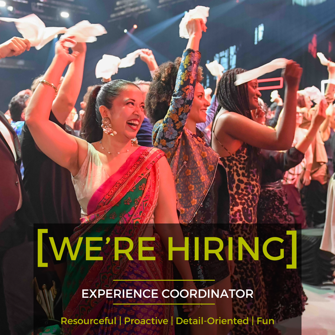 Dancers in colorful costumes on stage with “[WE’RE HIRING]” and “Experience Coordinator” text overlay