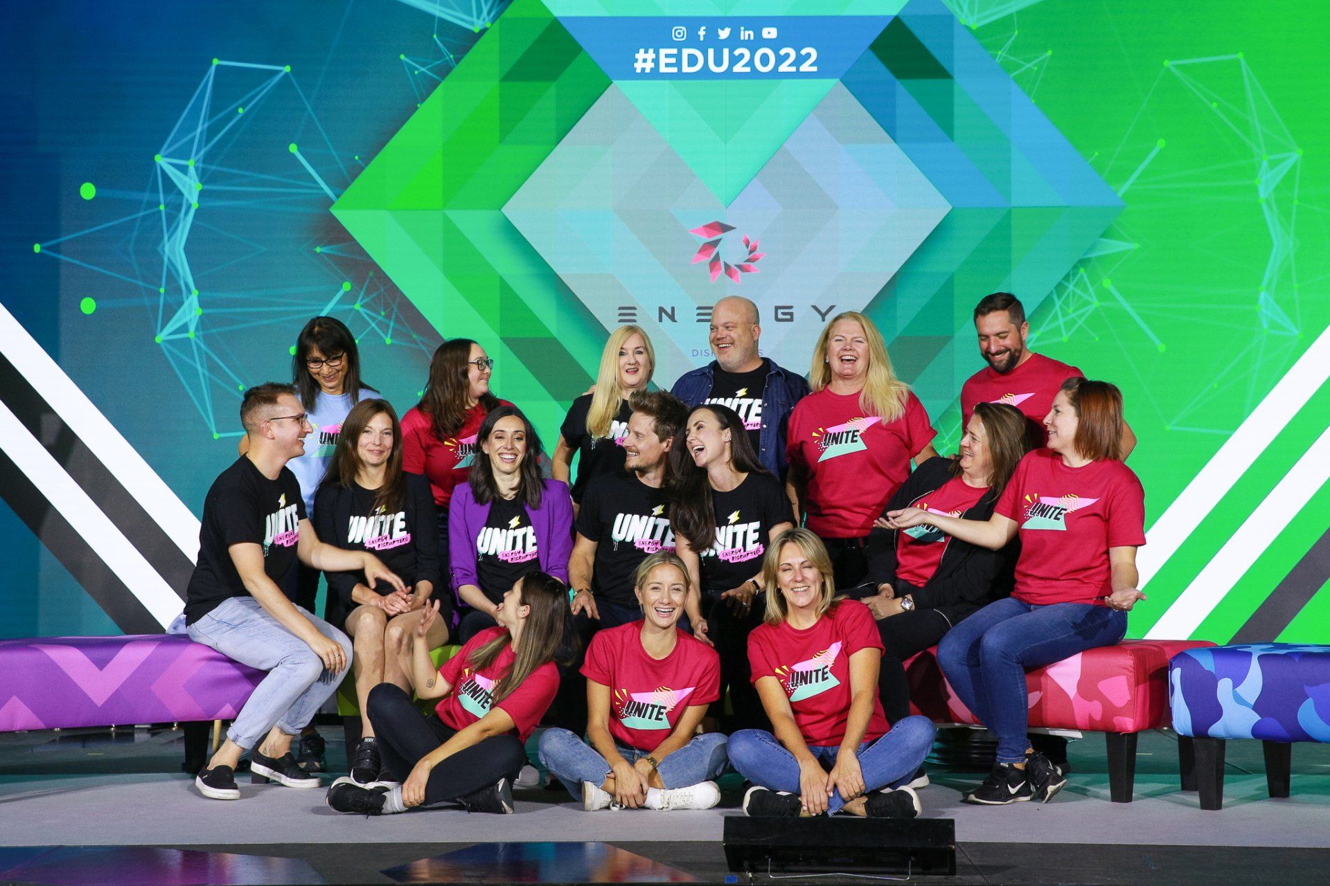 A group of people are posing for a picture on a stage.