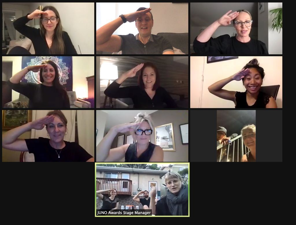 A group of people saluting on a video call