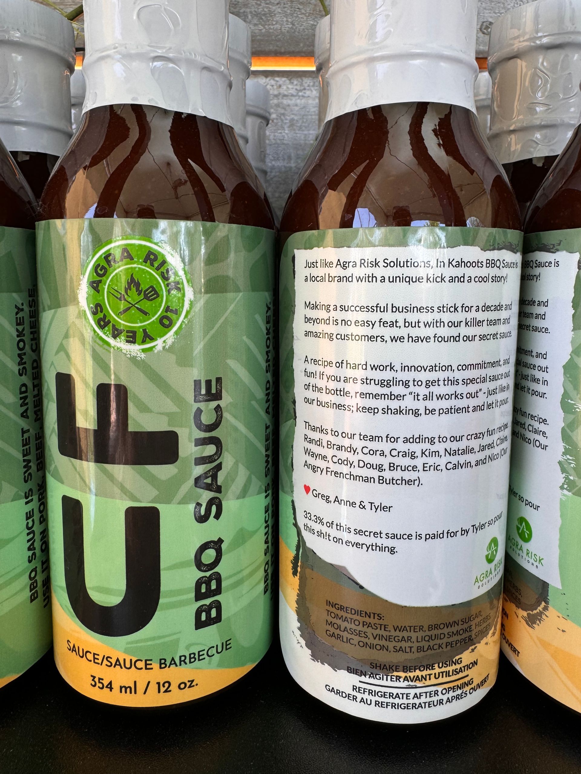 Bottles of UF BBQ sauce, green and brown labels.
