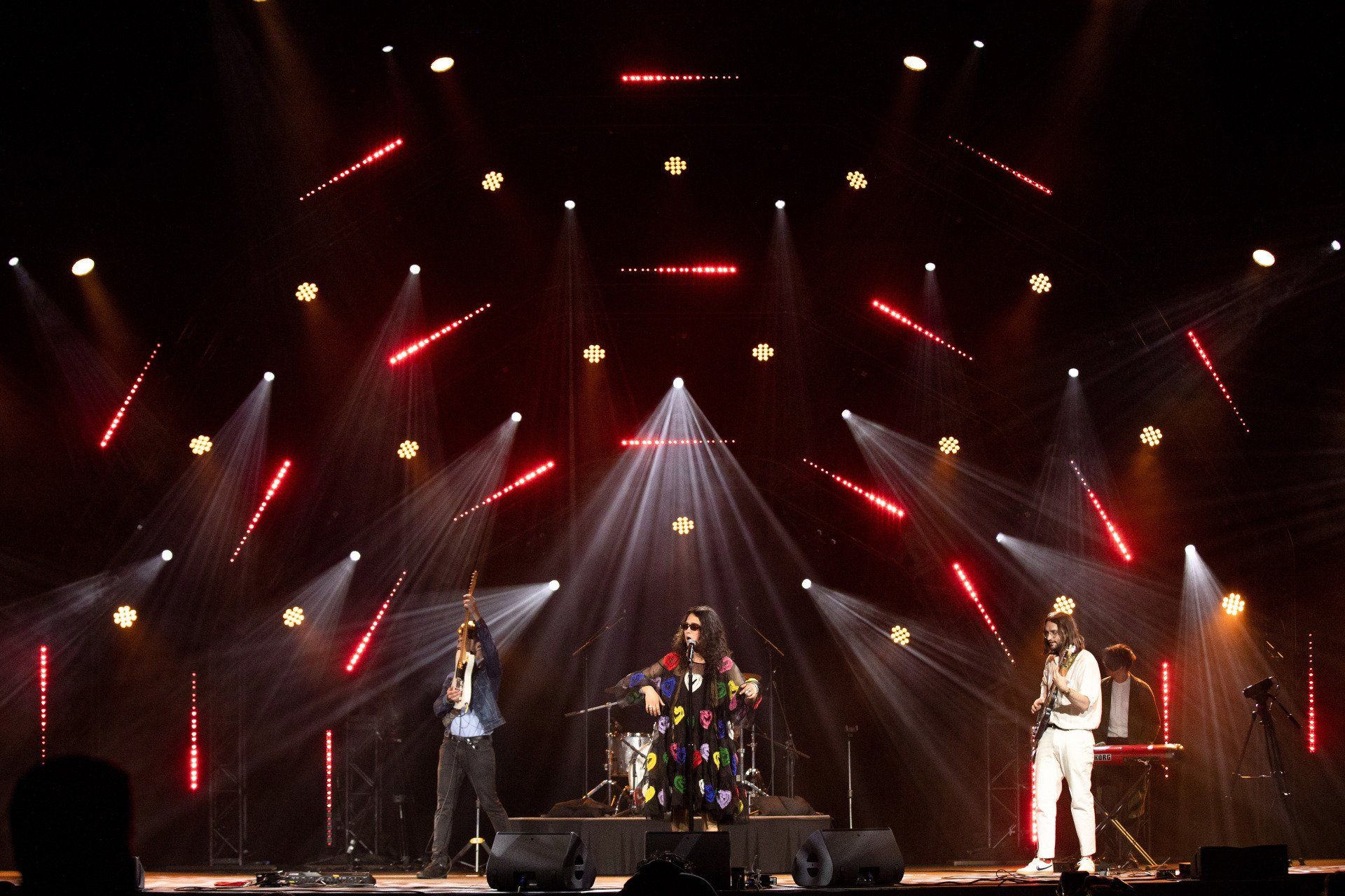 A group of people standing on a stage with lots of lights