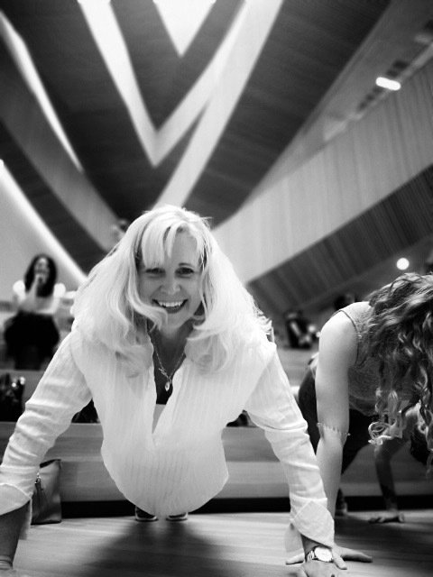 A black and white photo of a woman doing push ups