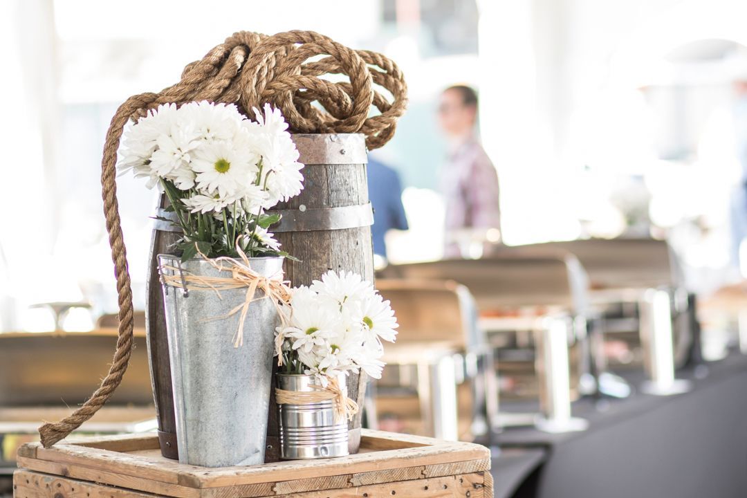 A bucket of flowers is sitting on top of a wooden box.