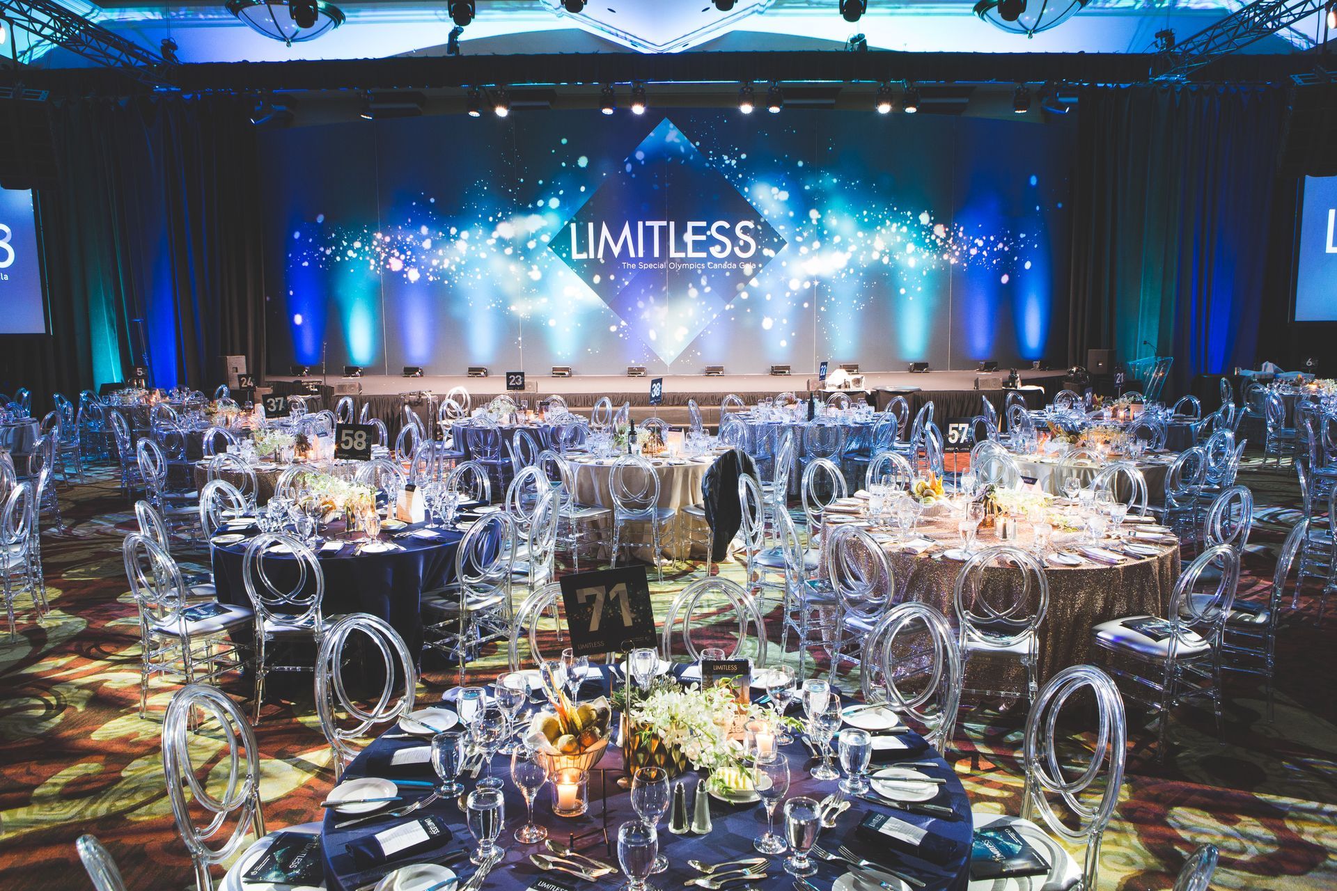 A large room with tables and chairs set up for a banquet.