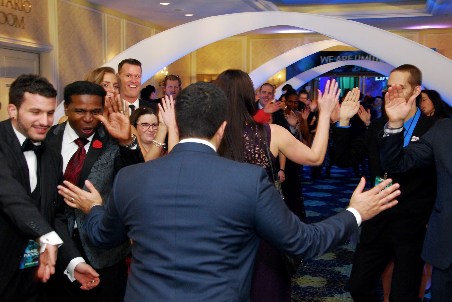 A man in a suit is dancing with a group of people