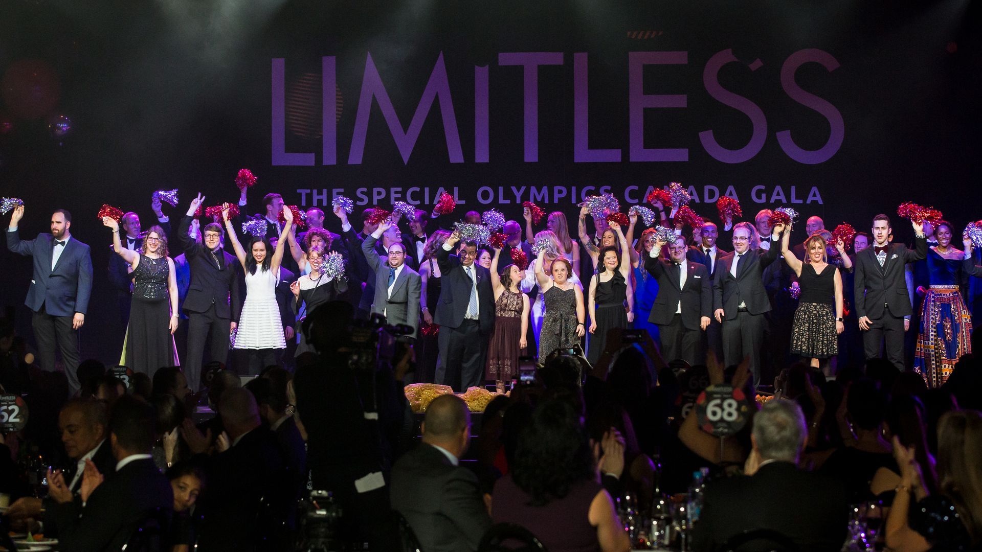 A group of people standing in front of a sign that says limitless