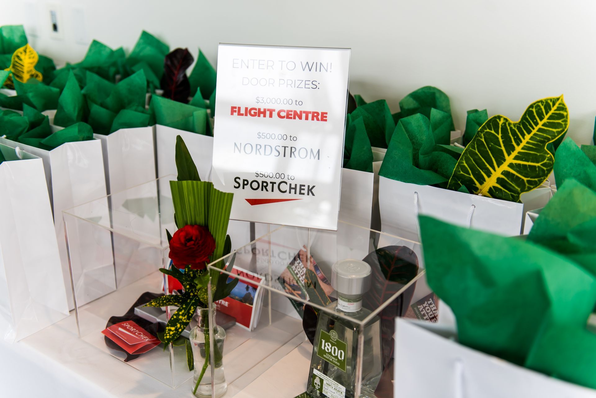 A table with a vase of flowers and a sign that says flight centre