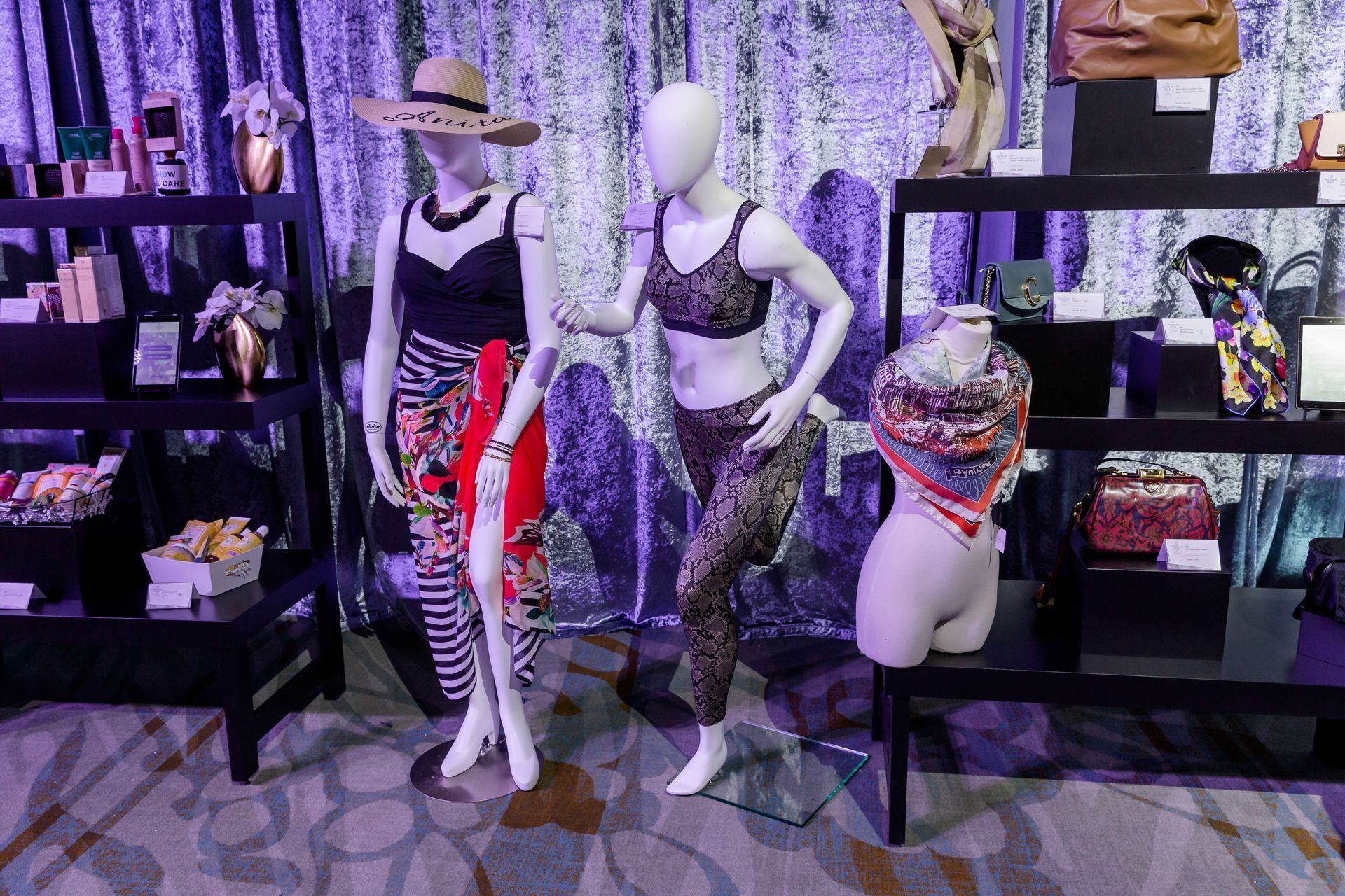 Three mannequins are standing next to each other in a room.