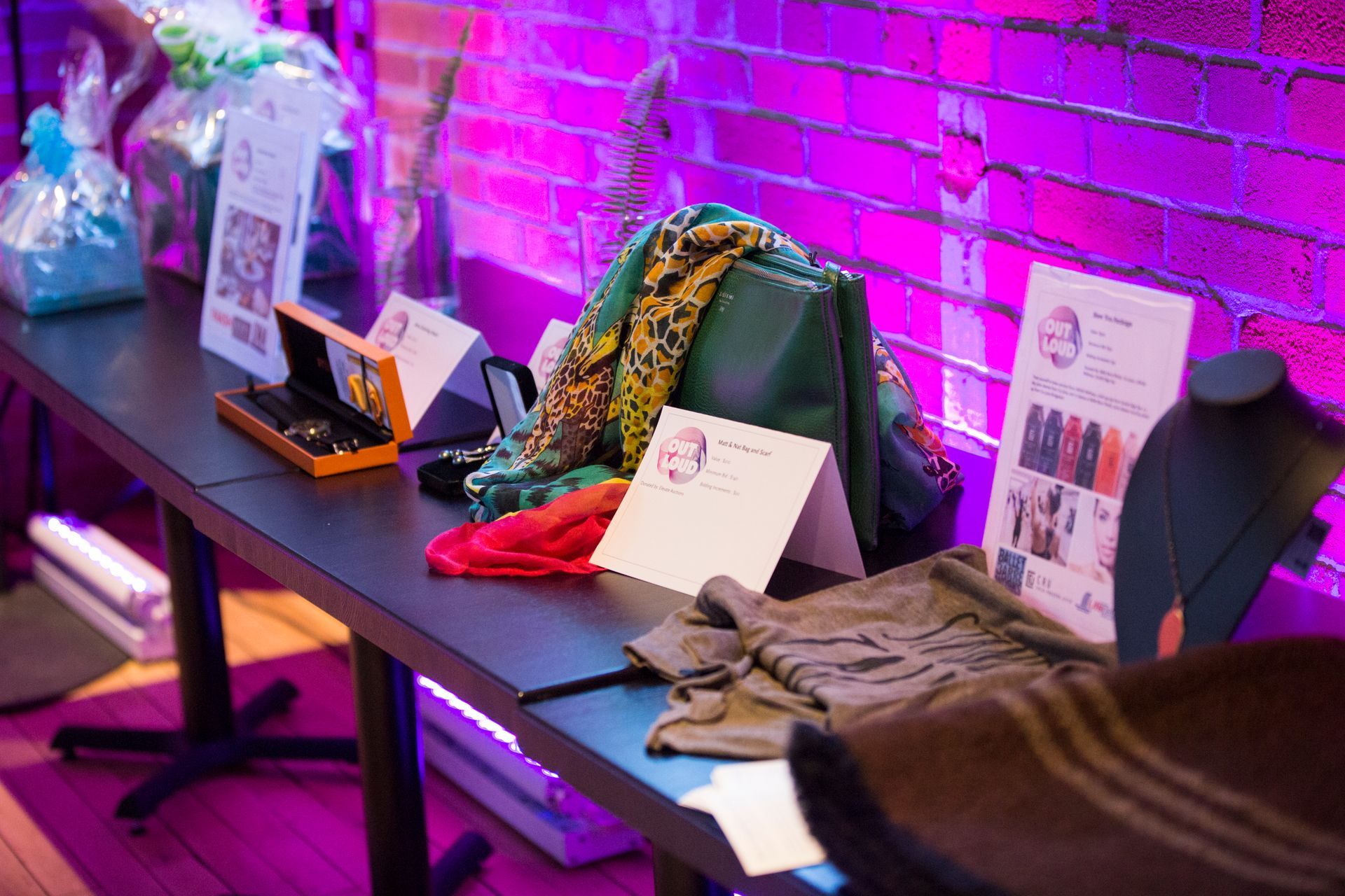 A table with a bunch of items on it in front of a brick wall.
