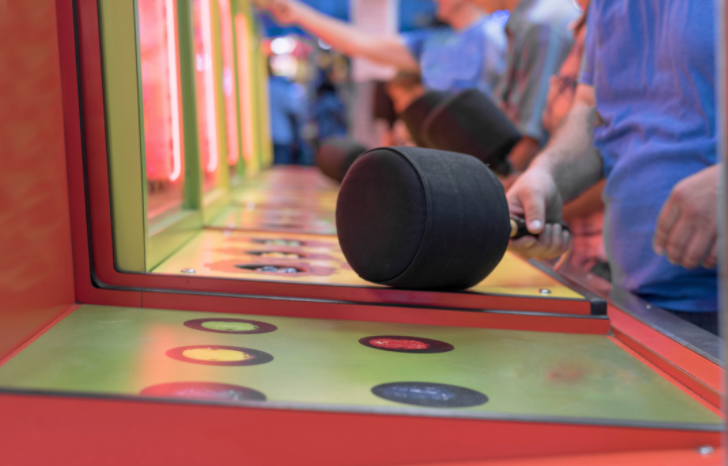 A group of people are playing a game in an amusement park.