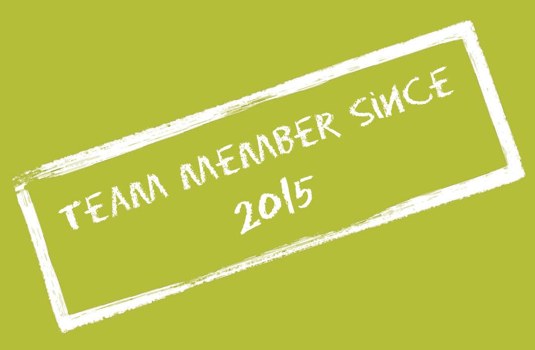 A stamp that says team member since 2015 on a green background
