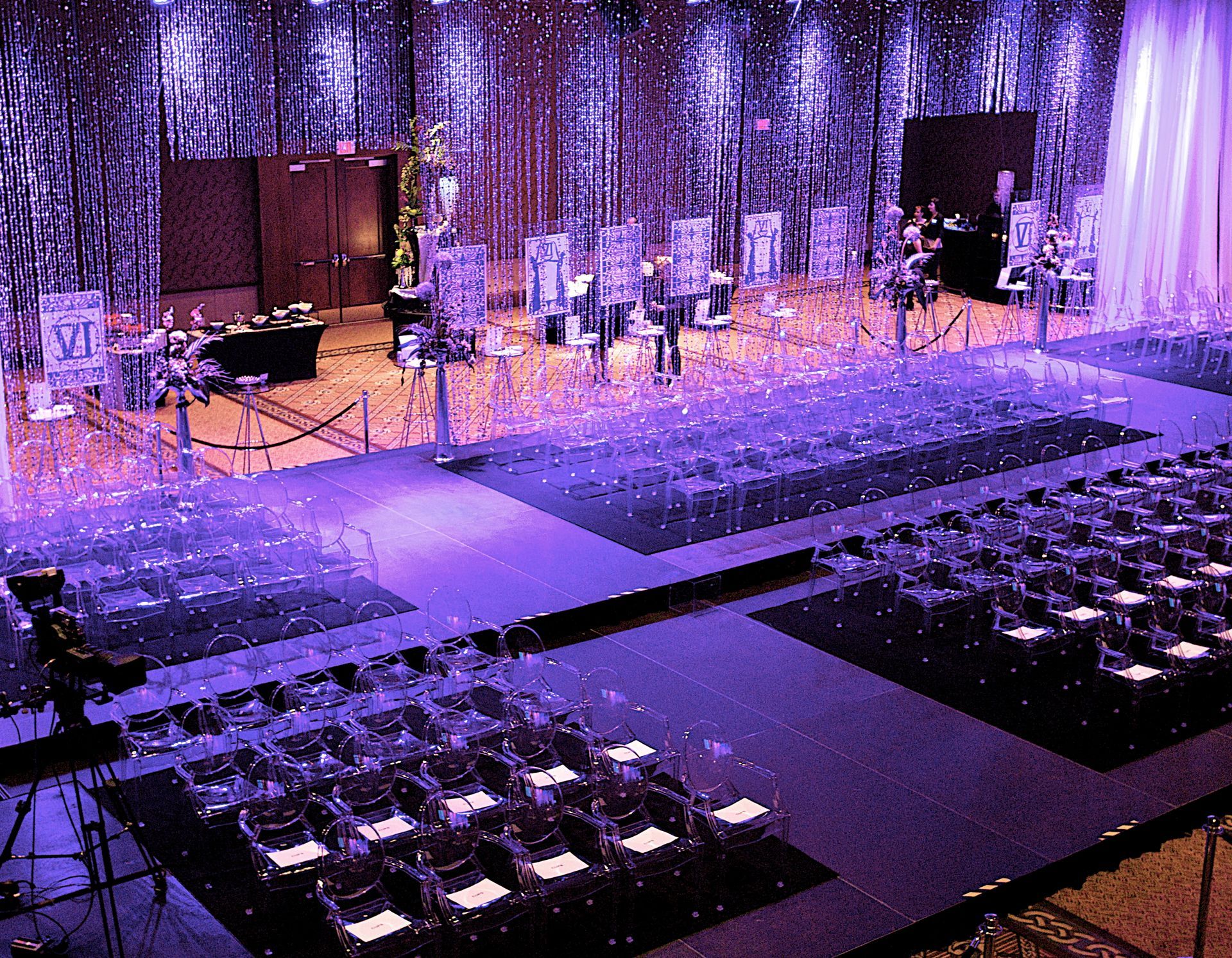 A large room with purple lights and tables and chairs