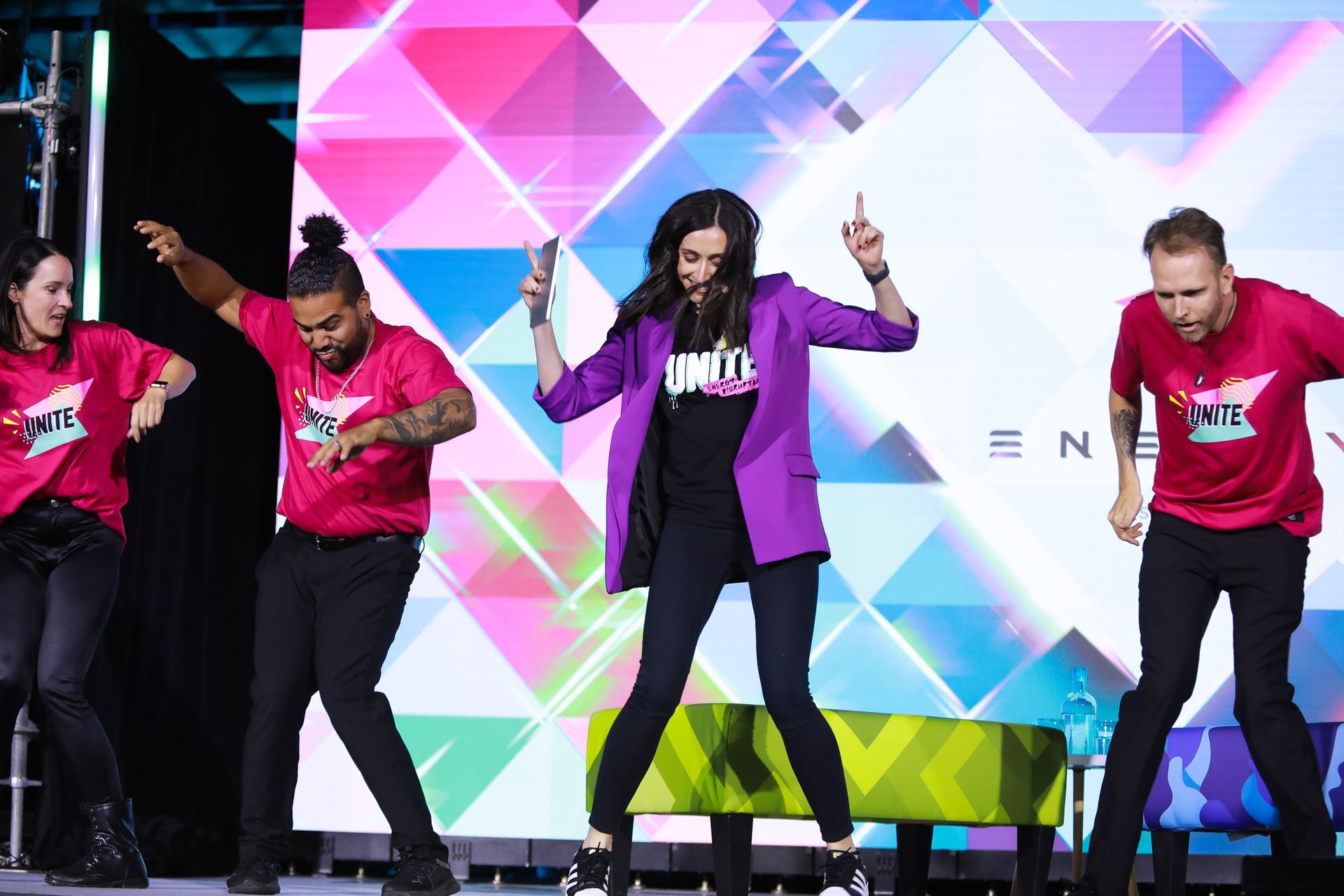 A group of people are dancing on a stage.