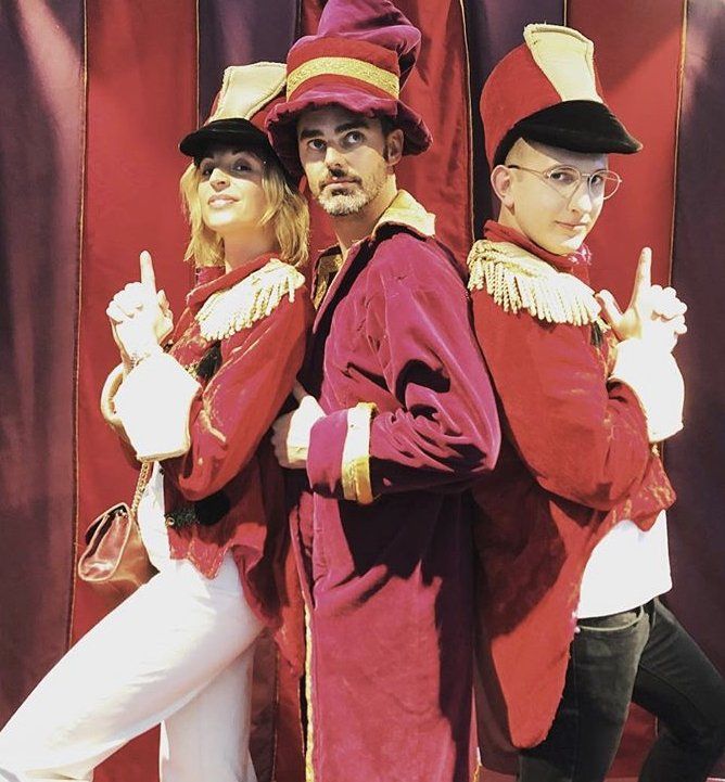 A man in a red hat is standing next to two other people